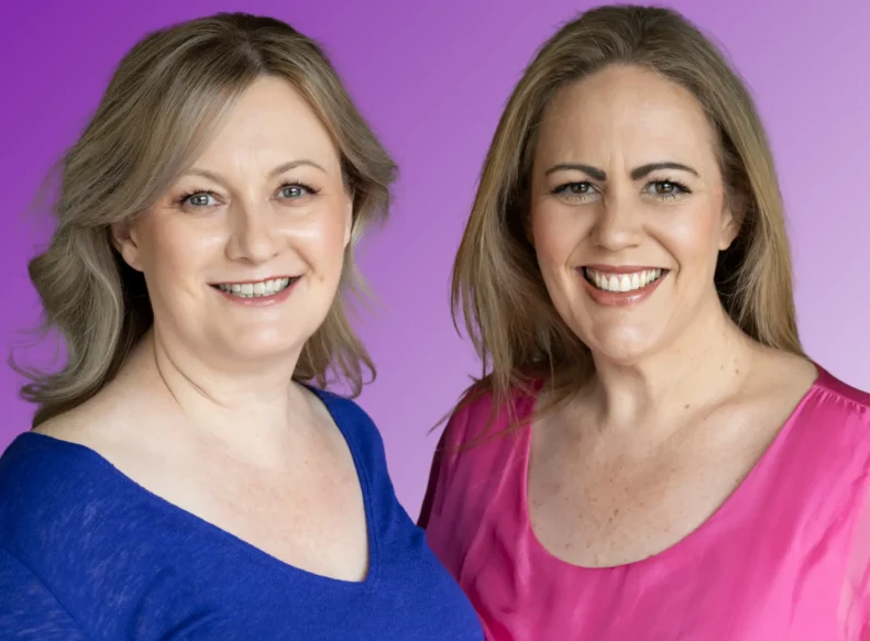 Two women smiling against a purple gradient background. The woman on the left, Christine from Targeted Training, is wearing a blue top. The woman on the right, Rebecca from Targeted Training, is wearing a pink top. Both women have light brown hair and are looking directly at the camera.-Image